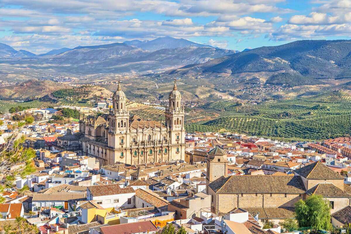 Aerial cityscape of Jaen with cathedral and Sierra Magina mountains on background, Andalusia, Spain